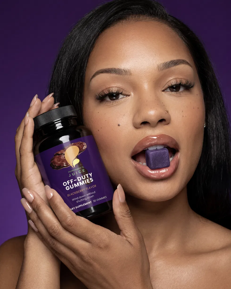 Off-Duty Gummies bottle held against a deep purple backdrop