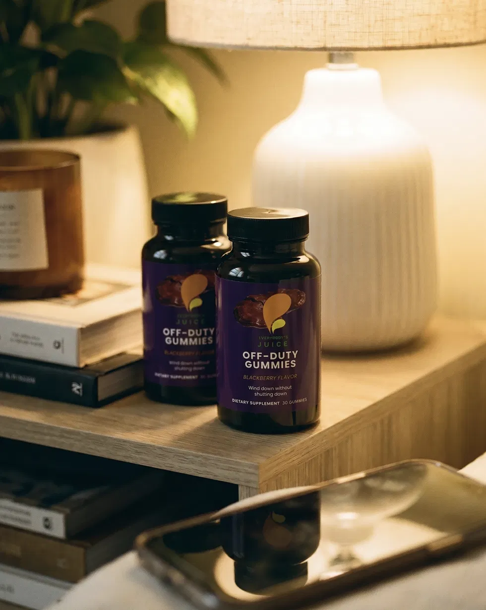 Two Off-Duty bottles on a warm-lit nightstand