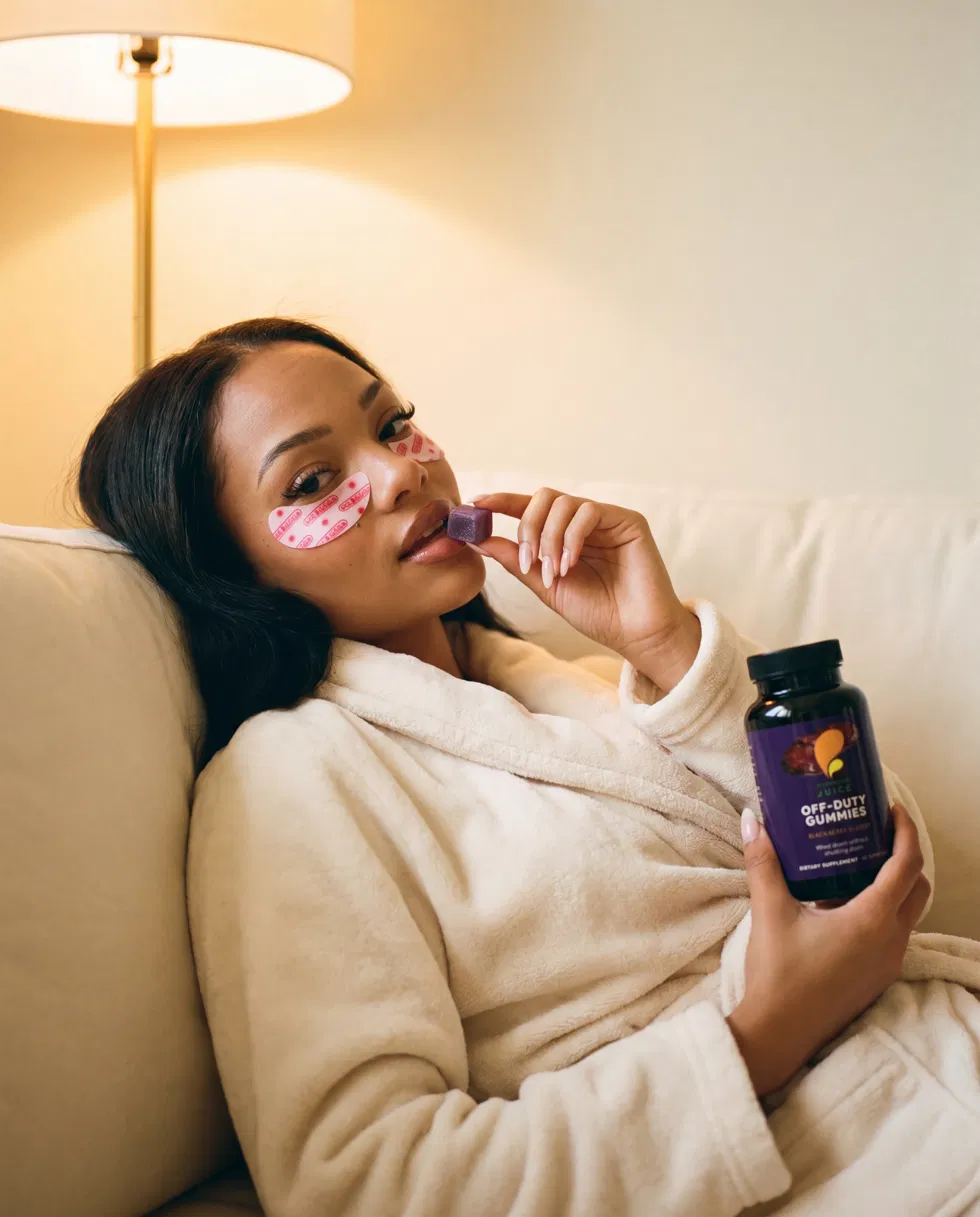 Woman in a plush robe with under-eye masks holding Off-Duty
